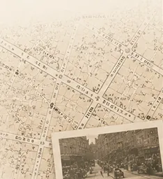 An antique city street map layered with a historical streetscape photograph